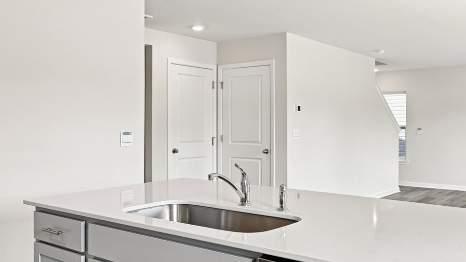 Kitchen and island with quartz countertops.