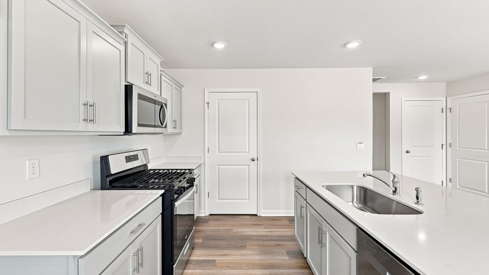 Kitchen and island with quartz countertops.