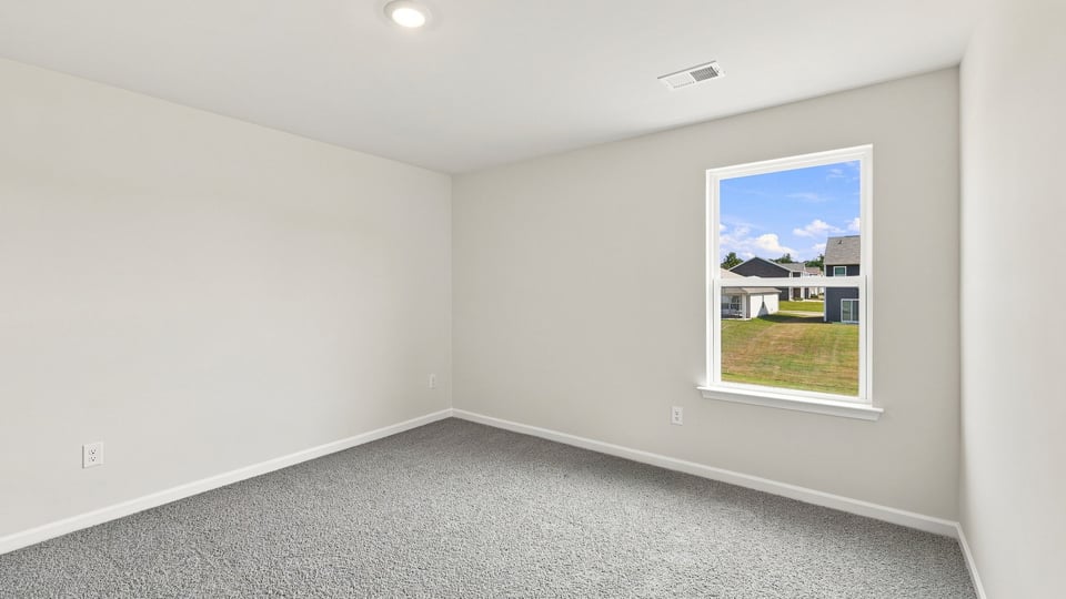 Bedroom with carpet and window.