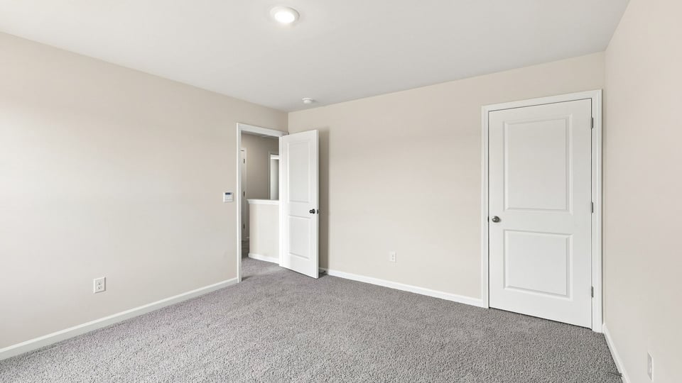Bedroom with carpet and window.