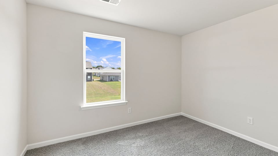 Bedroom with carpet and window.