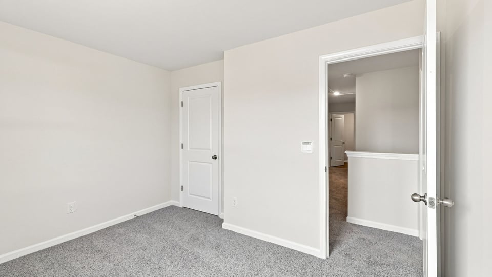 Bedroom with carpet and window.