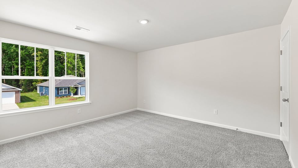 Bedroom with carpet and window.