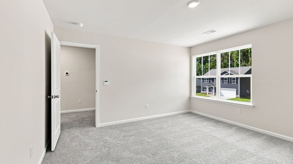 Bedroom with carpet and window.