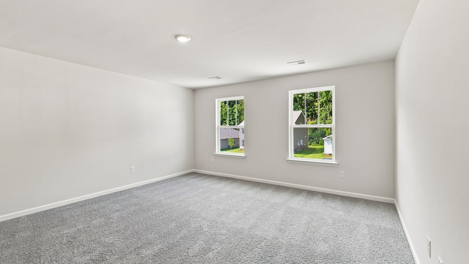 Bedroom with carpet and window.