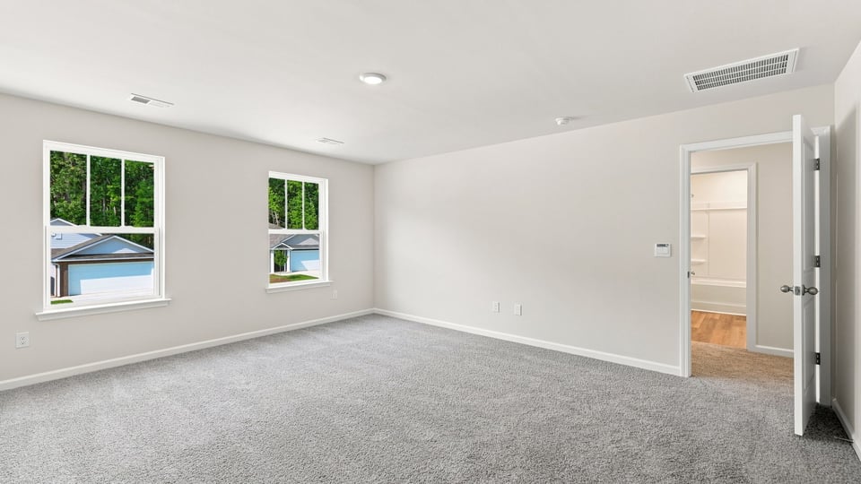 Bedroom with carpet and window.