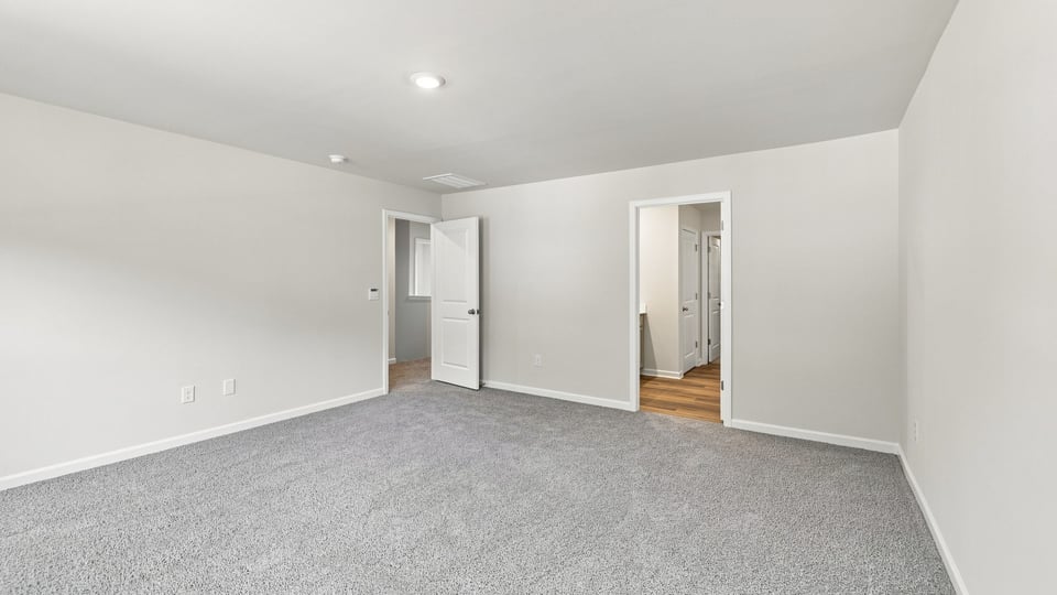 Bedroom with carpet and window.