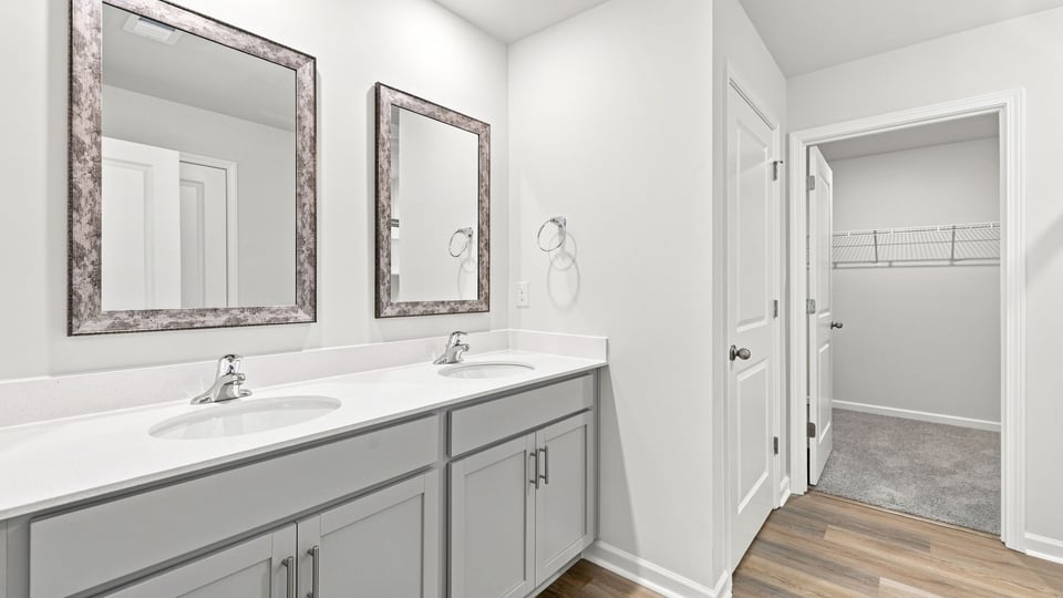 Bathroom with double vanity sink and closet.