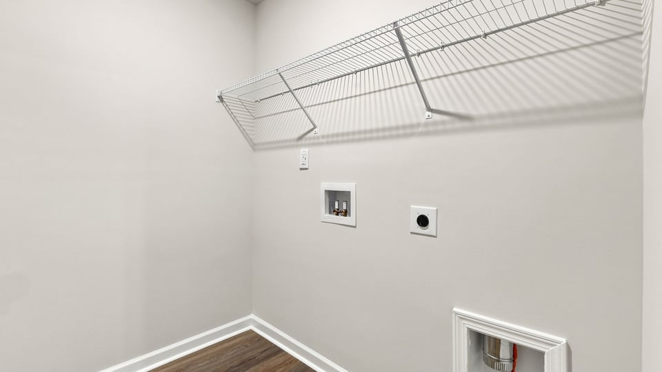 Laundry room with hanging storage racks.