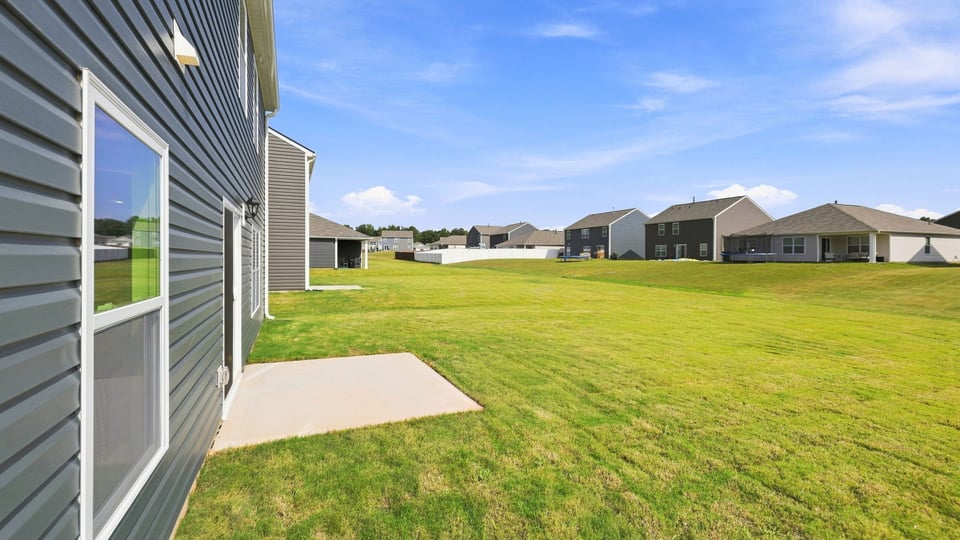 Back exterior of home with patio.