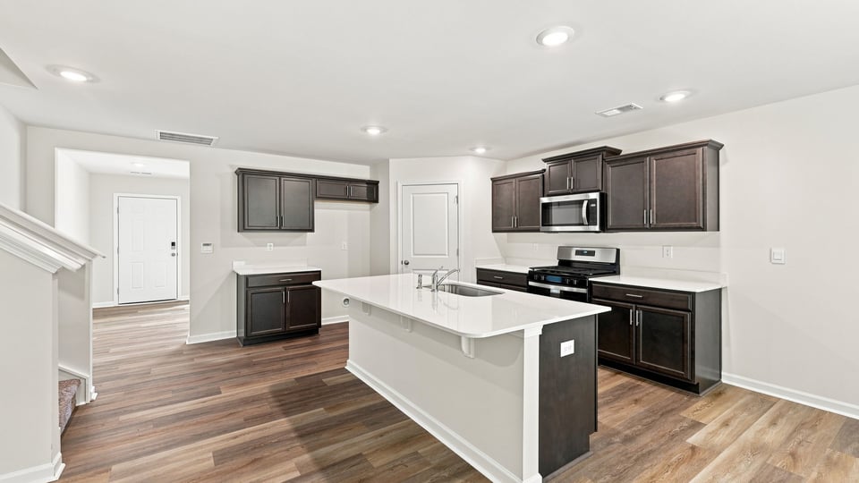 Kitchen and island with quartz countertops.