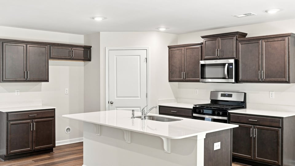 Kitchen and island with quartz countertops.