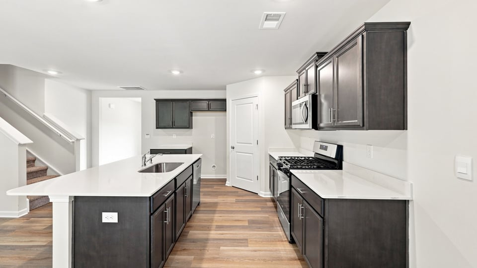Kitchen and island with quartz countertops.