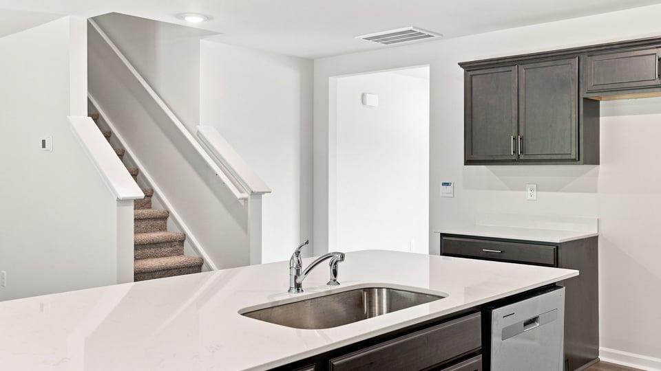 Kitchen and island with quartz countertops.