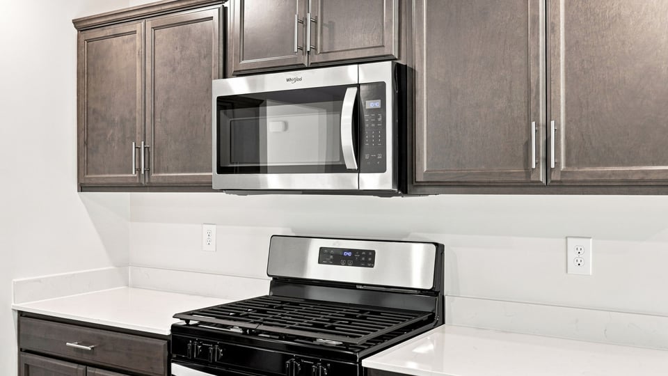 Kitchen and island with quartz countertops.