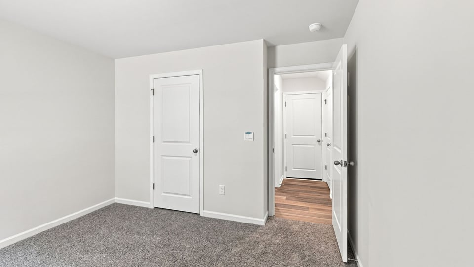 Bedroom with carpet and window.