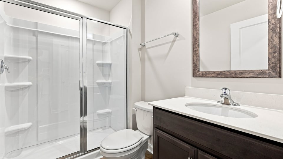 Bathroom with single vanity sink and walk in shower.