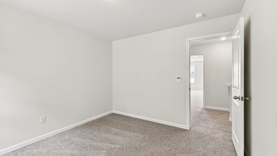 Bedroom with carpet and window.