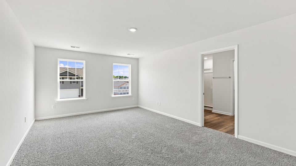 Bedroom with carpet and window.