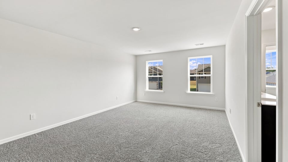 Bedroom with carpet and window.
