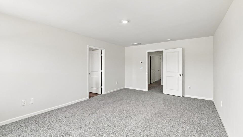 Bedroom with carpet and window.