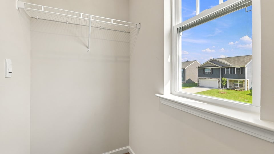 Closet with hanging storage racks.