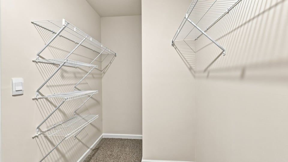 Closet with hanging storage racks.