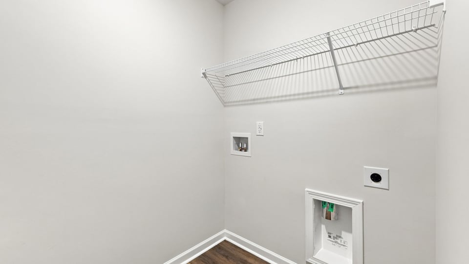 Laundry room with hanging storage racks.