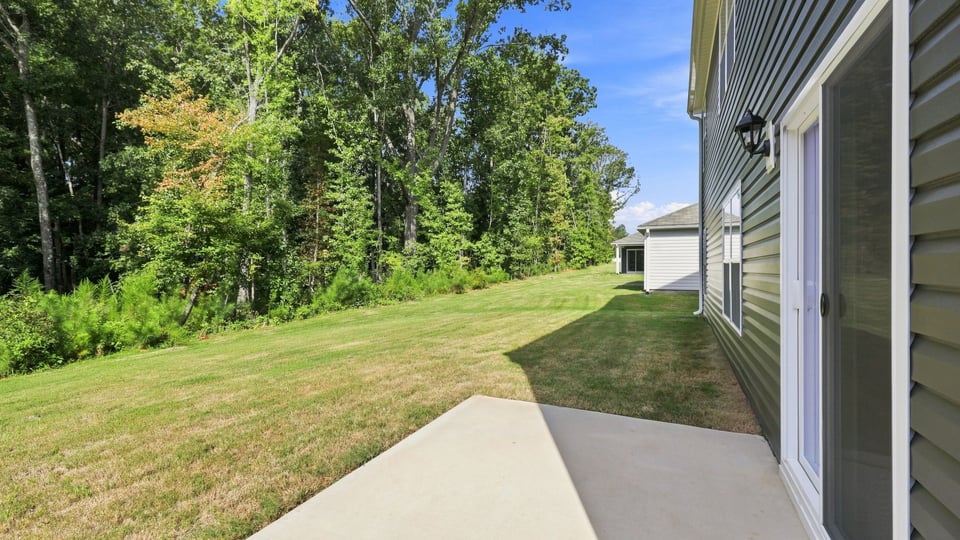 Back exterior of home with patio.