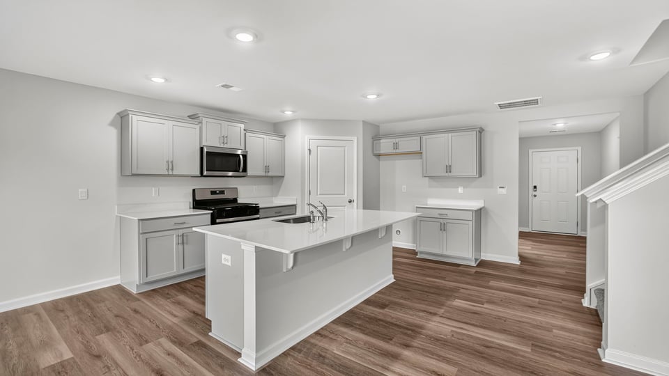 Kitchen with island and cabinets.