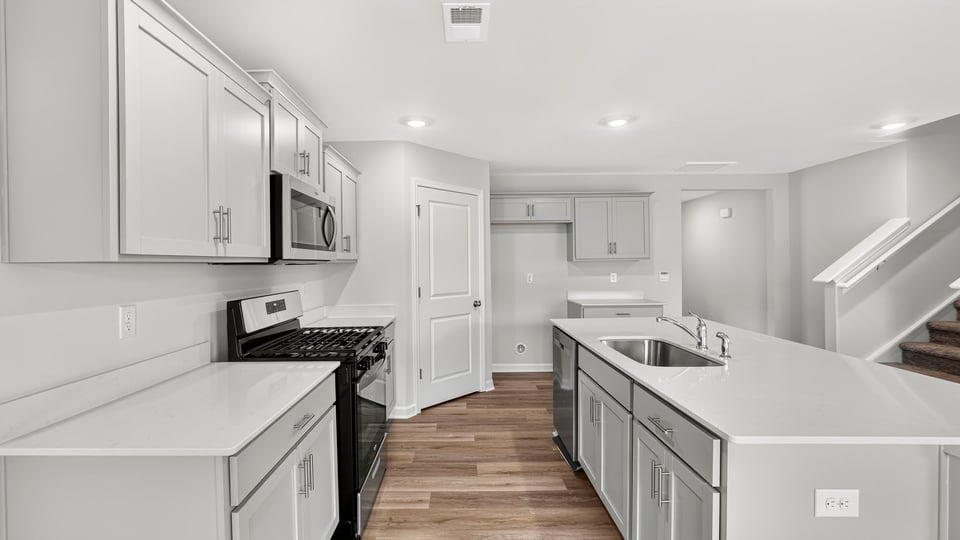 Kitchen with island and cabinets.