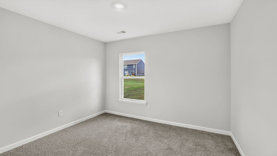 Bedroom with carpet and windows.