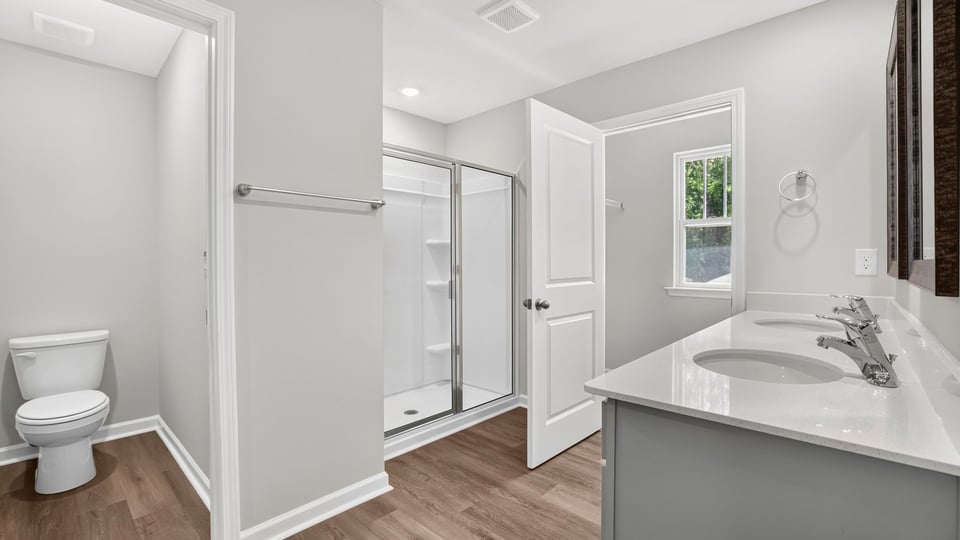 Primary bathroom with double vanity sinks.a