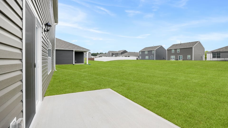 Back exterior with large backyard.