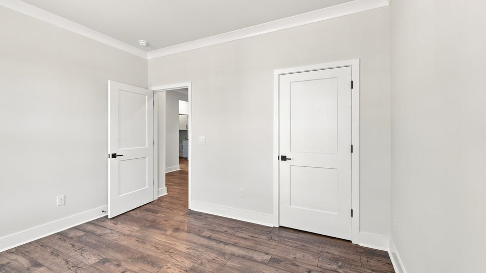 Bedroom with closet and window.