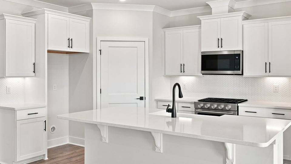 Kitchen with island and cabinets.