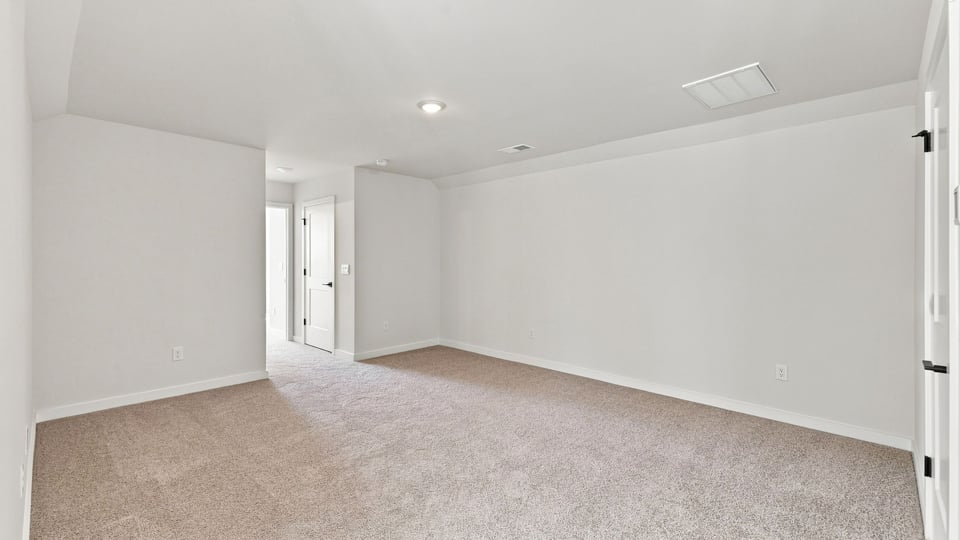 Loft with carpet and windows.