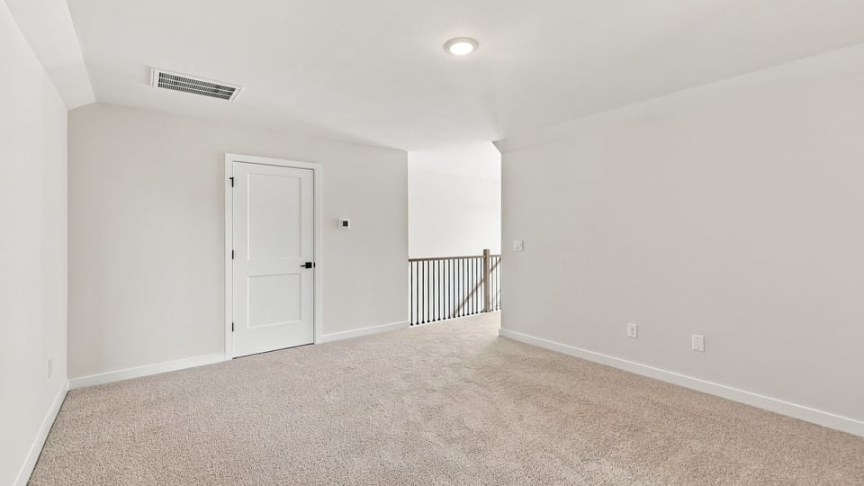 Loft with carpet and windows.
