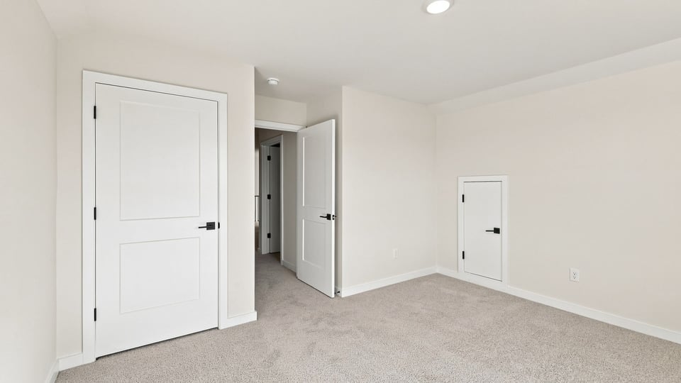 Bedroom with carpet and windows.