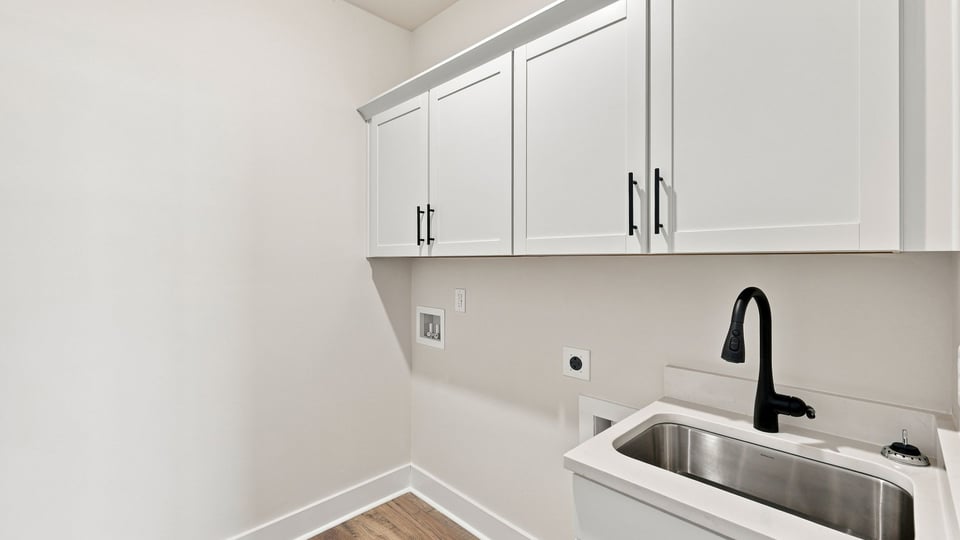 Laundry room with cabinets.