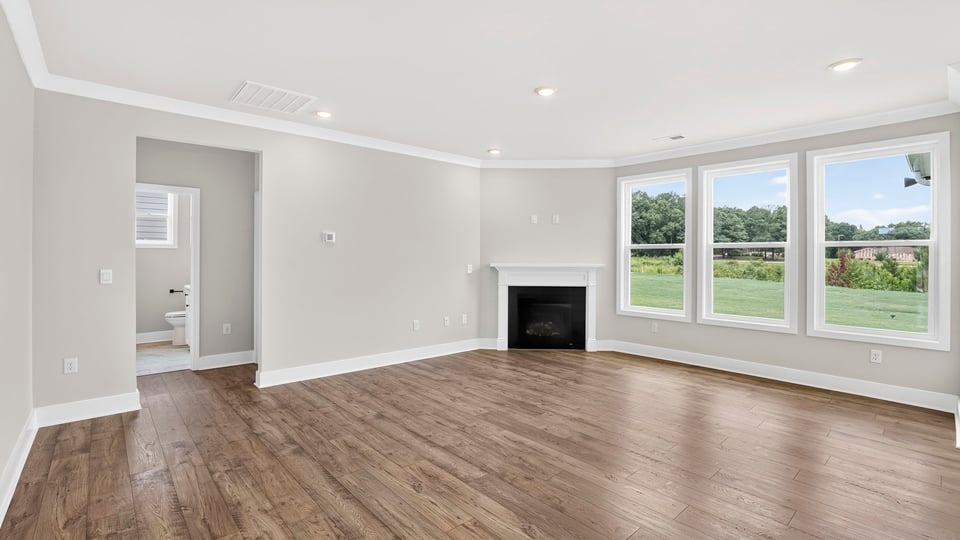 Living room with fireplace and windows.
