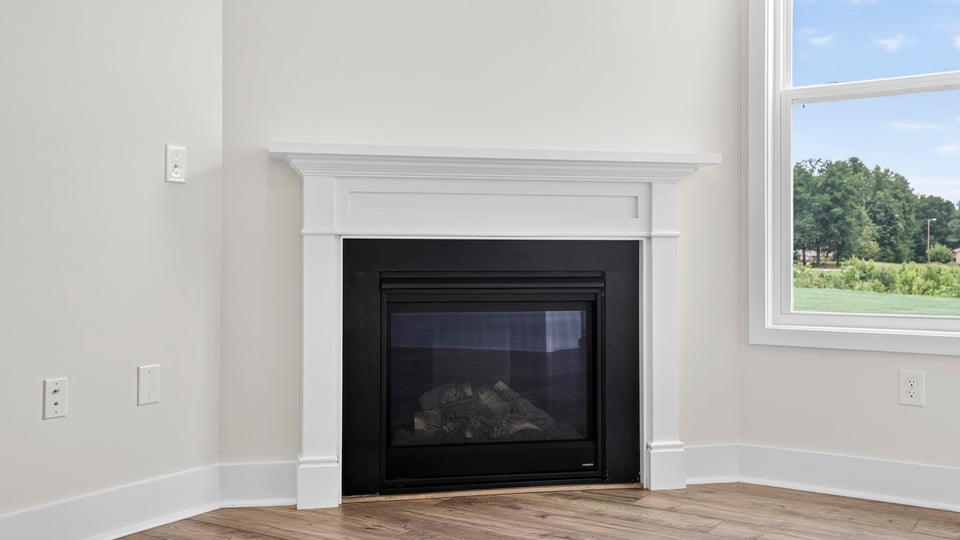 Living room with fireplace and windows.