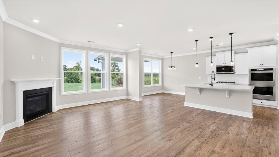 Living room with fireplace and windows.