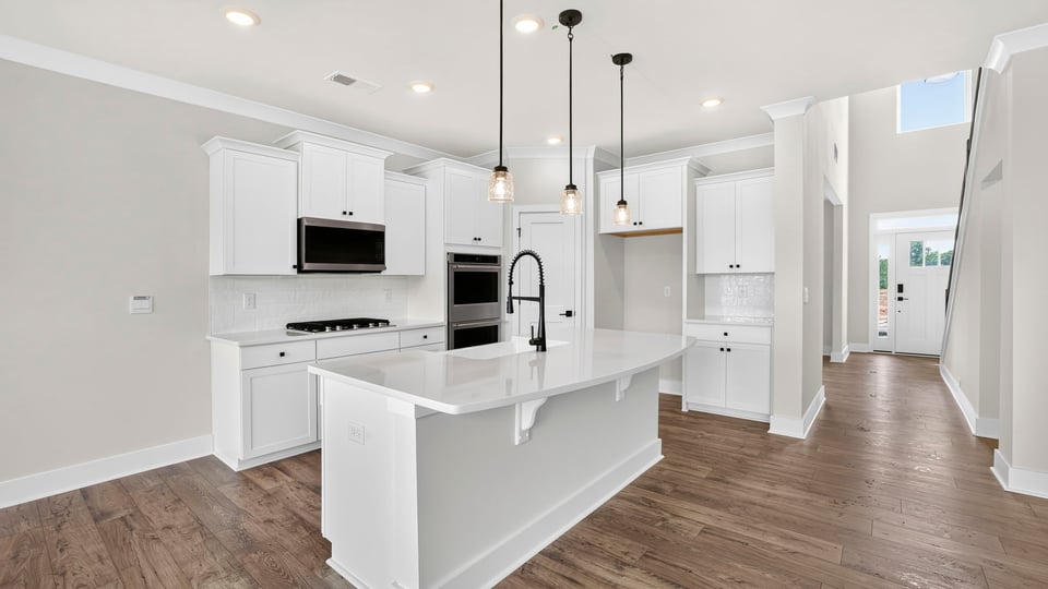 Kitchen and island with quarzt countertops.
