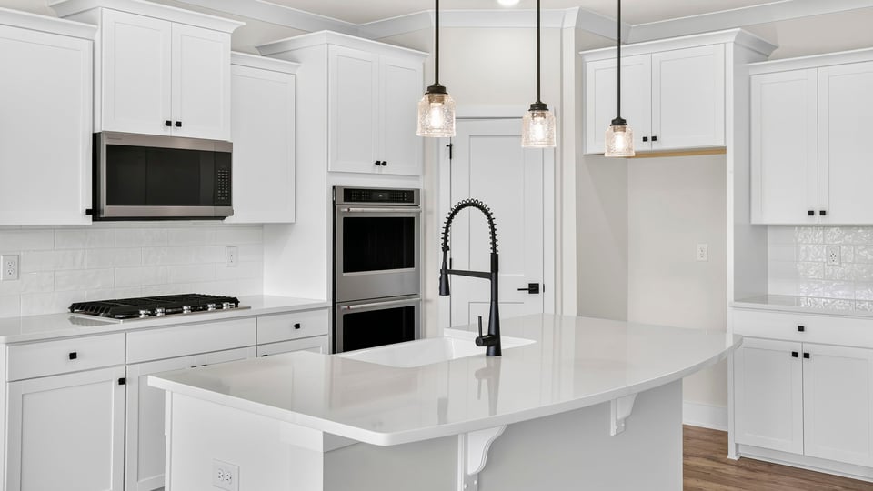 Kitchen and island with quarzt countertops.
