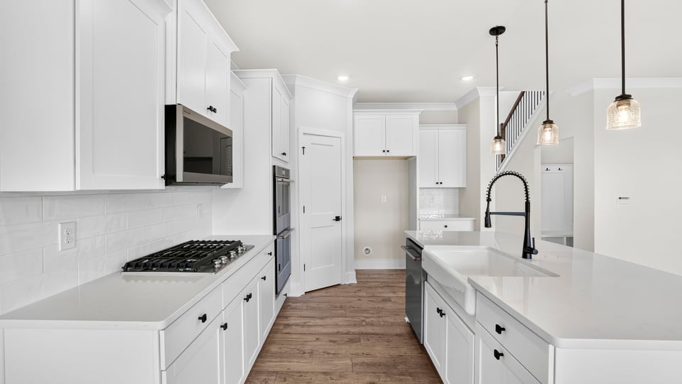 Kitchen and island with quarzt countertops.