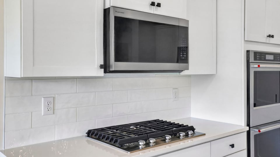Kitchen and island with quarzt countertops.
