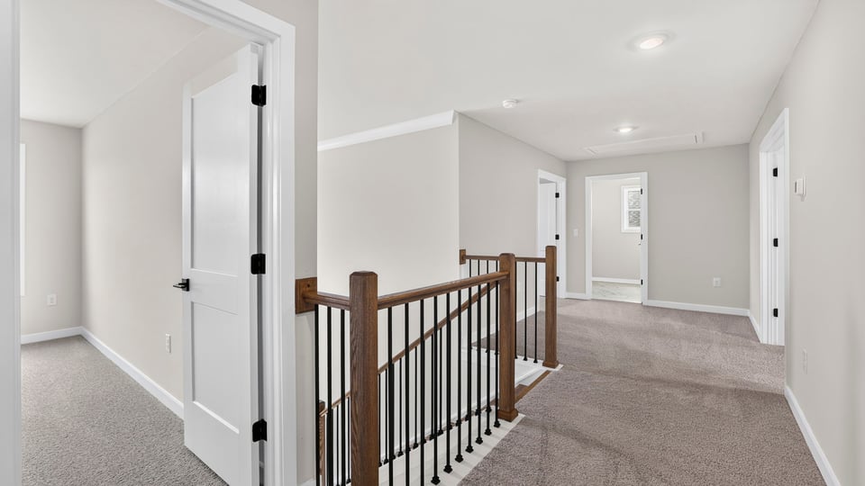 Loft area with carpet and window.