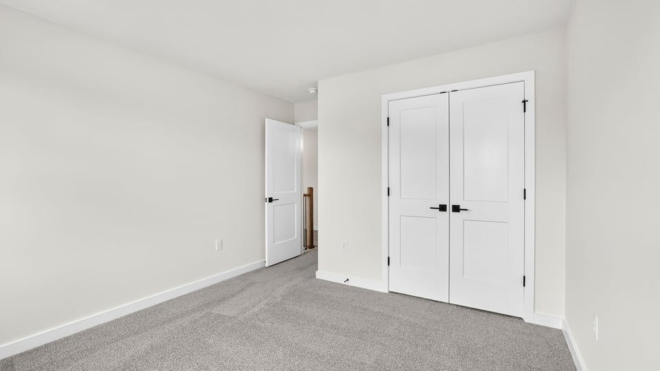 Bedroom with carpet and windows.