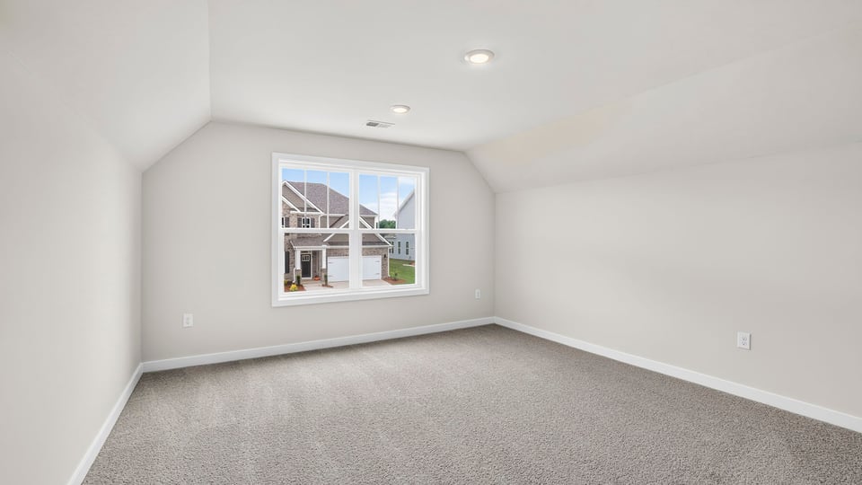 Bedroom with carpet and windows.
